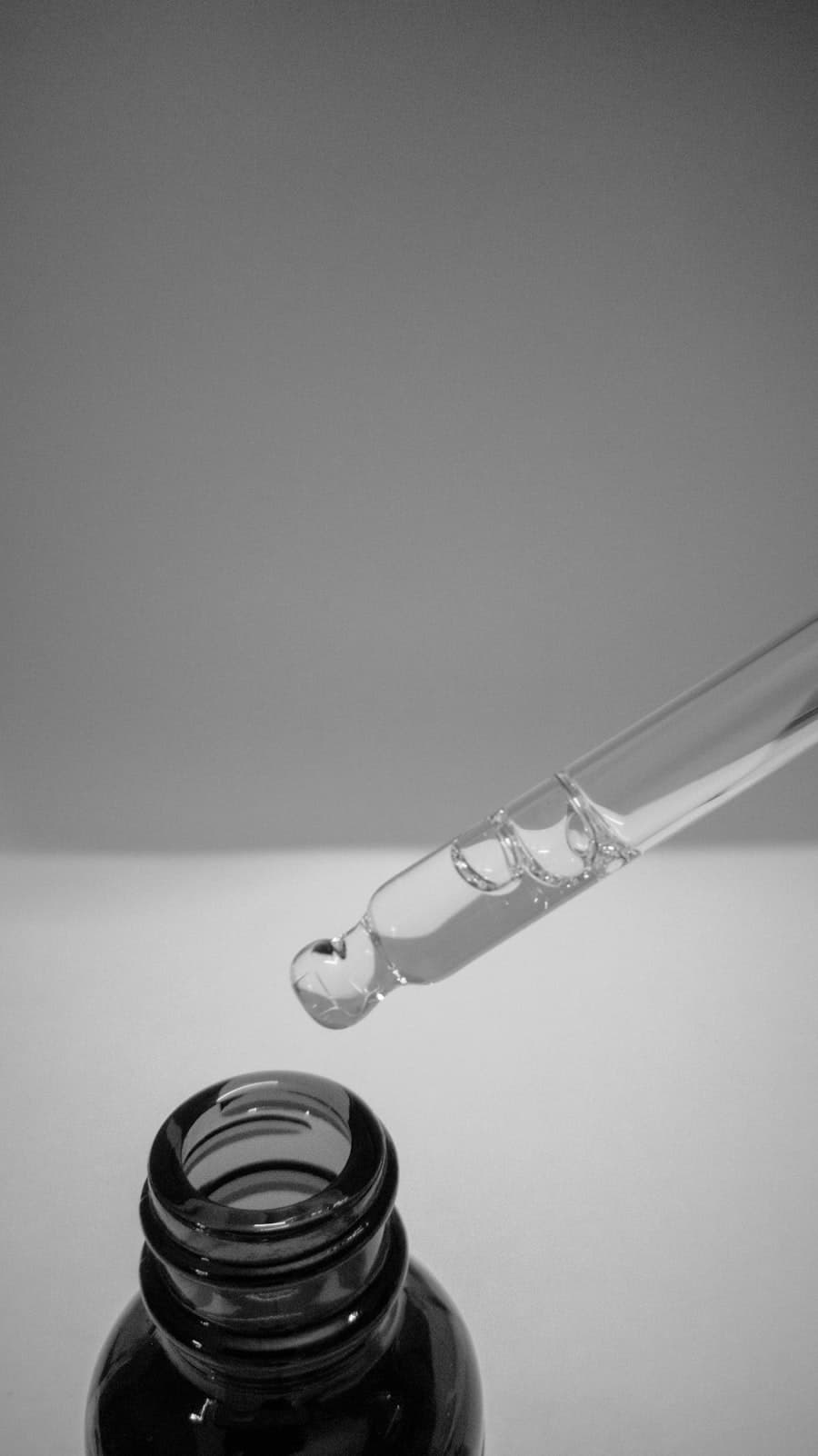A glass dropper bottle of clear serum