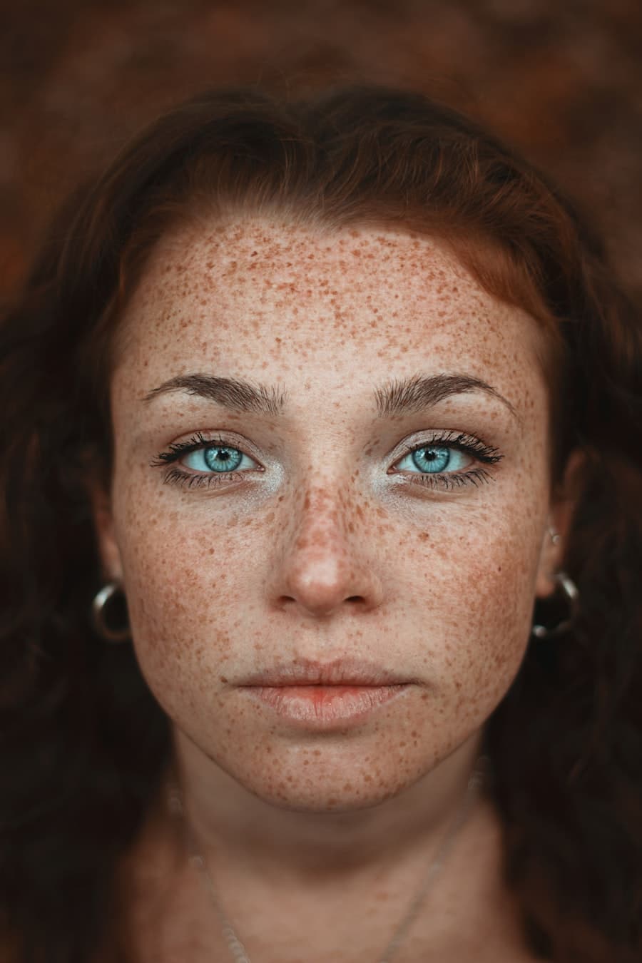 Close portrait of a woman with freckled skin