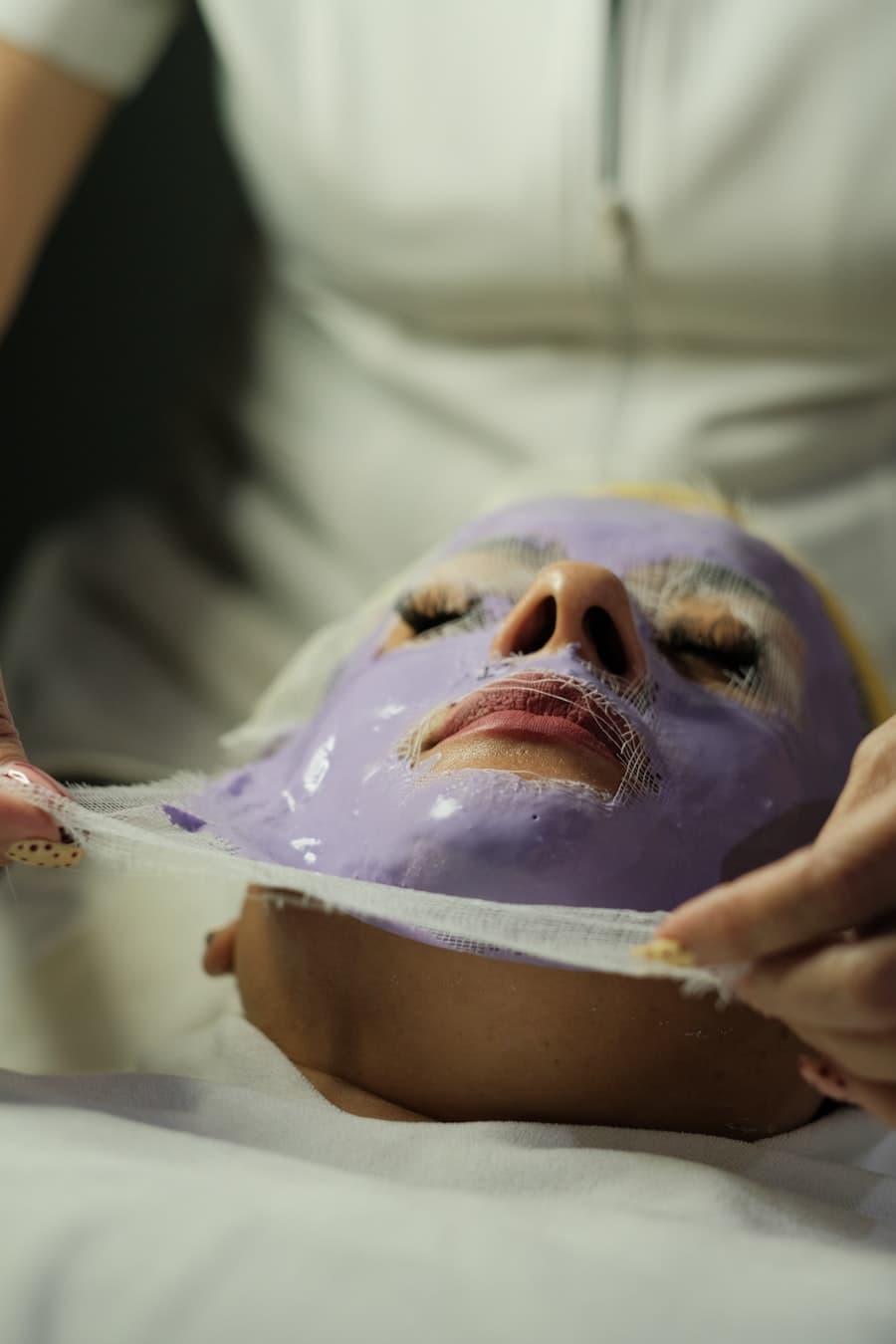 A treatment mask being lifted from a face